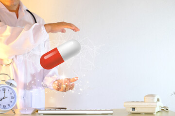 Concept of a doctor holding medical tablets and capsules, as well as a healthcare hospital service. Medical technology and innovation are concepts of scientific technology in healthcare.