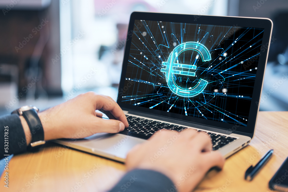 Poster close up of businessman hands using laptop keyboard with euro sign on screen on wooden desktop workp