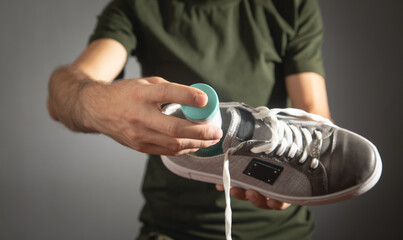 Man using antibacterial spray against unpleasant odors.
