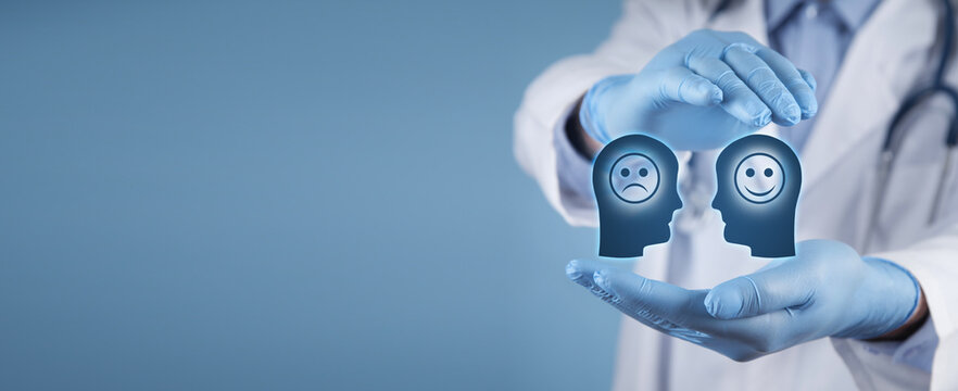 Doctor showing human head with a sad and happy smiling face.