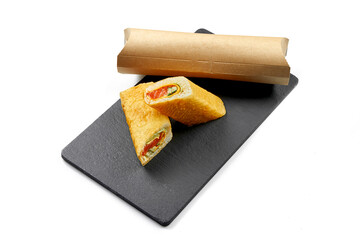 Sushi burrito with salmon in maminori on black board. Close-up, selective focus. White background.