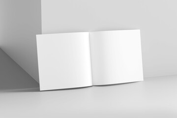 Fototapeta premium Mockup of opened blank square ctalogue at white design wall background
