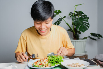 Asian lesbians smiling happily On the dining table with Thai food, papaya salad and grilled...