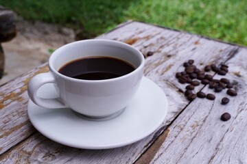hot americano coffee on old wooden table.