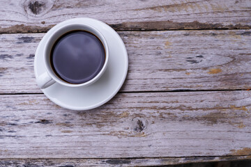 hot americano coffee on old wooden table.