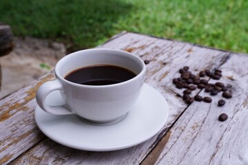 hot americano coffee on old wooden table.