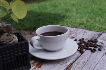 hot americano coffee on old wooden table.