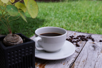 hot americano coffee on old wooden table.