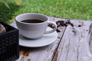 hot americano coffee on old wooden table.