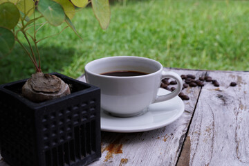 hot americano coffee on old wooden table.