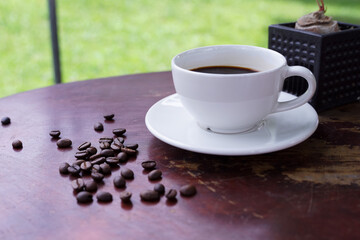 hot americano coffee on old wooden table.