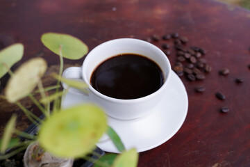hot americano coffee on old wooden table.