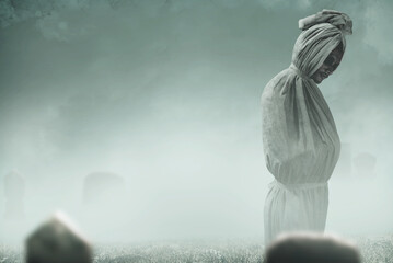 Pocong is covered with a white linen shroud standing