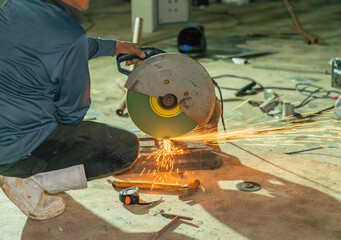 Worker use circle fiber cutting steel and sparks.