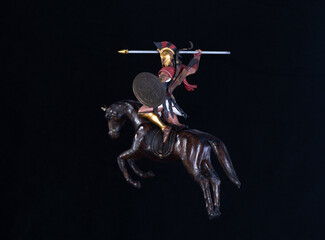 gladiator on horseback isolated on black background