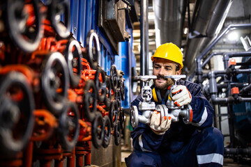 Industrial maintenance service and experienced engineer changing pipe valves in refinery plant.