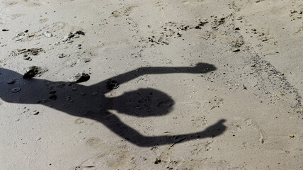 Child's shadow on the beach