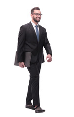 Obraz na płótnie Canvas side view. smiling businessman with laptop stepping forward