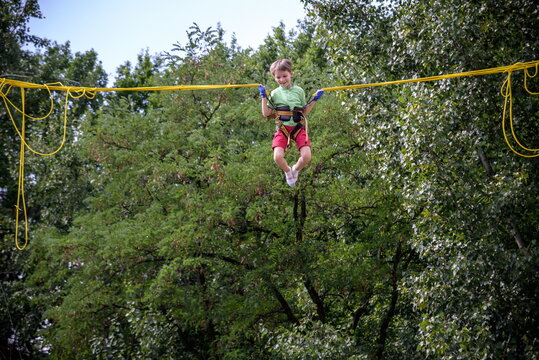 The boy is jumping on a bungee trampoline. A child with insuranc