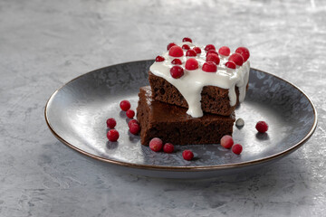Brownie with sour cream and cranberries. Chocolate dessert.  Selective focus.