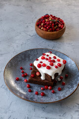 Brownie with sour cream and cranberries. Chocolate dessert.  Selective focus.