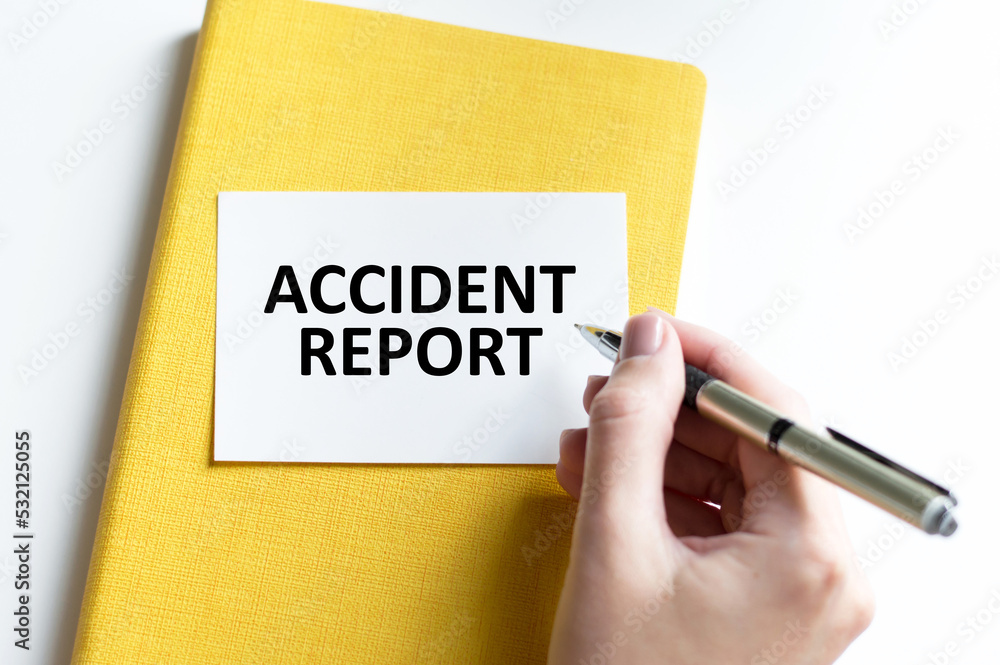 Poster accident report inscription on a card against the background of a notepad on the table next to the h