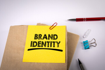 Brand Identity. Stack of books with text on a yellow sheet of paper