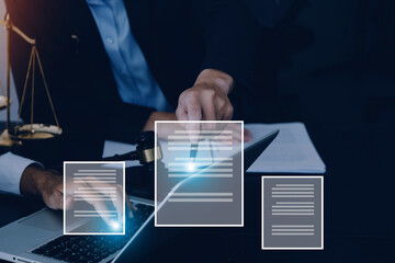 Justice and law concept.Male judge in a courtroom with the gavel, working with, computer and docking keyboard, eyeglasses, on table in morning light