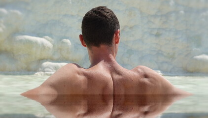 Pamukkale, Turkey. White chalk mountains. A man is resting in the water. Selective Soft Focus