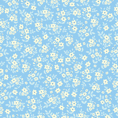 Simple vintage pattern. small white flowers. light blue  leaves. blue background. Fashionable print for textiles and wallpaper.