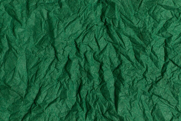 Green crumpled paper background. Full frame texture.