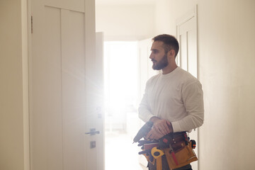 Portrait Young Male Carpenter Repairing Door Lock