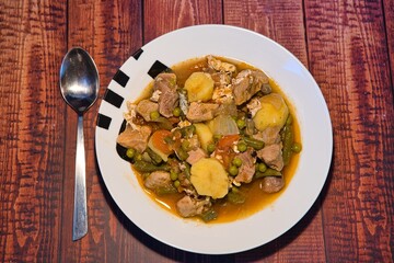 Meat stew on your plate on a wooden background. world food day concept.
