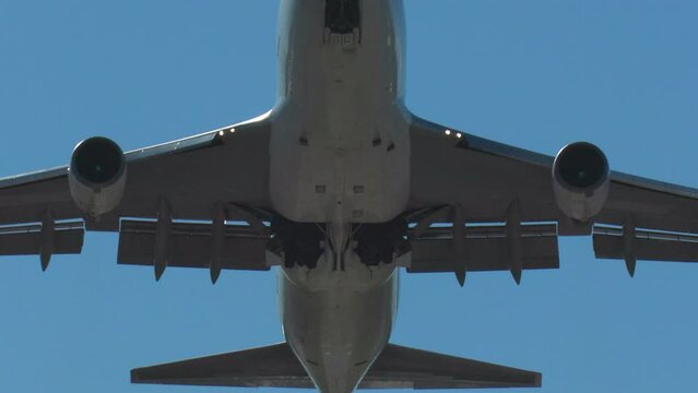 huge airplane passing overhead gear retraction slow motion