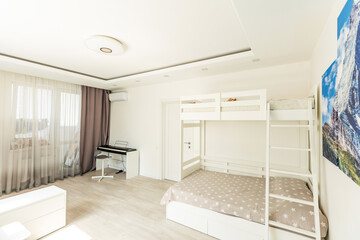 Stylish composition of cozy scandinavian child's room interior with wooden bed, toys and hanging decorations. Creative wall.