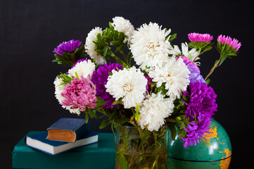 World Teacher's day concept. Flowers bunch, pencils globe and books pile