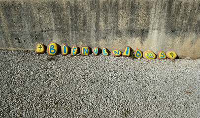 welcome message written each letter on a stone at the entrance to the Roncesvalles pilgrim hostel
translation: 