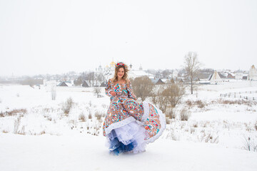 beautiful Russian girl in a winter national dress - obrazy, fototapety, plakaty