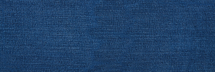 Banner Macro jeans textured background. Blue denim pattern top view and copy space. Template blank backdrop. Fashion cloth pattern mockup. Top view flat lay vintage trousers material. Selective focus