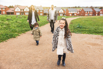 Happy multiracial family enjoying walk at town park together - 532136049