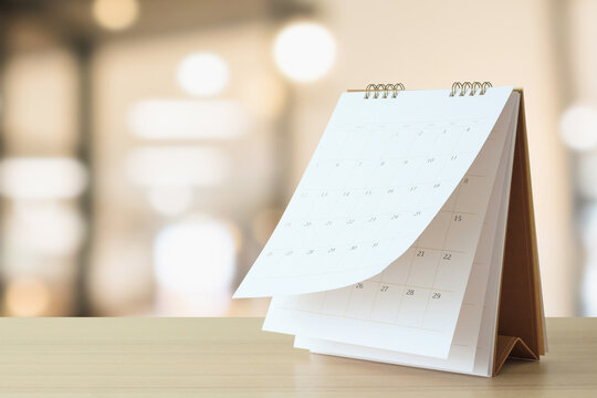 desk calendar on table with blurred bokeh background appointment and business meeting concept