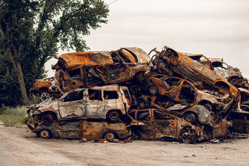 Burnt cars. Cemetery. Cars of civilians shot up. Russia is the aggressor. War in Ukraine 