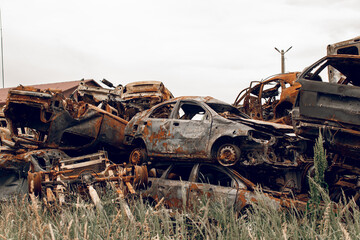 Burnt cars. Cemetery. Cars of civilians shot up. Russia is the aggressor. War in Ukraine 