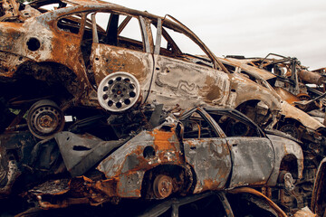 Burnt cars. Cemetery. Cars of civilians shot up. Russia is the aggressor. War in Ukraine 