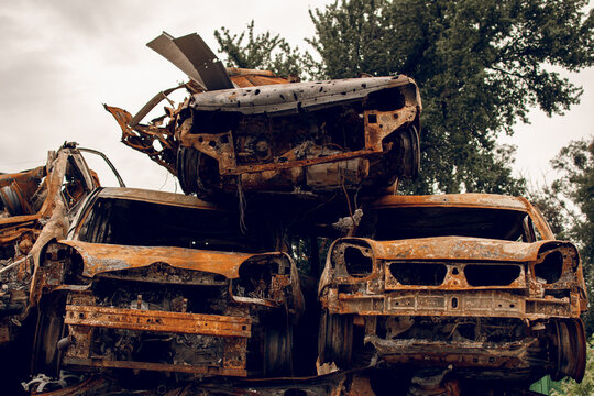 Burnt cars. Cemetery. Cars of civilians shot up. Russia is the aggressor. War in Ukraine 