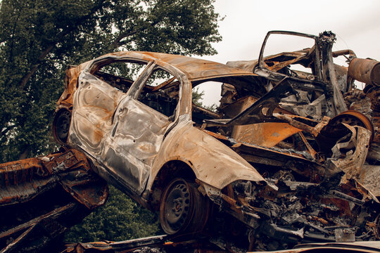 Burnt cars. Cemetery. Cars of civilians shot up. Russia is the aggressor. War in Ukraine 
