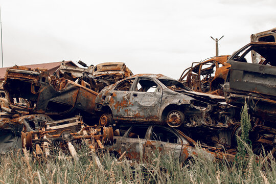 Burnt cars. Cemetery. Cars of civilians shot up. Russia is the aggressor. War in Ukraine 