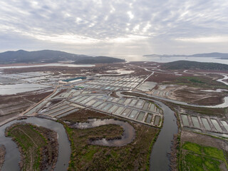 Aerial view of fish farming pools at land. Sea fish farm. Cages for fish farming dorado and seabass. 