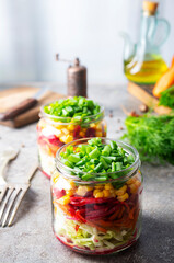 Fresh salad of autumn vegetables - purple and green cabbage, carrots, green onions. salad in bank