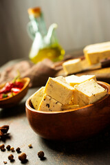 Bowl with tasty tofu cheese on table